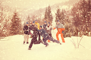 Image showing group of young people having fun in beautiful winter landscape