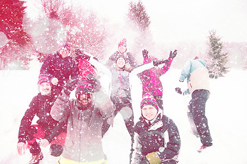 Image showing group of young people throwing snow in the air