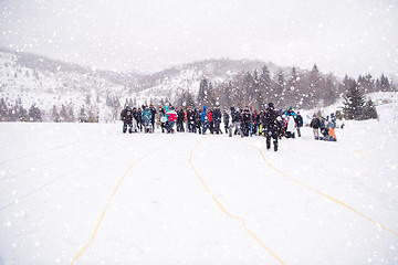 Image showing group of young people having a running in bag competition