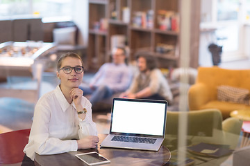 Image showing businesswoman using a laptop in startup office