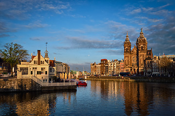 Image showing Amsterdam canal and Church of Saint Nicholas on sunset