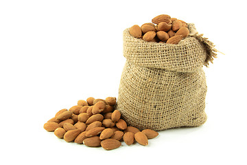 Image showing Natural Whole Almonds nuts in burlap bag. 