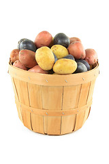 Image showing Mini potatoes with different color in wooden basket. 