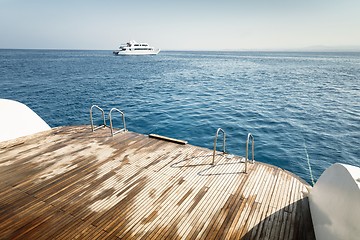 Image showing Wet boat deck against blue ocean