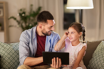 Image showing father and daughter listening to music on tablet