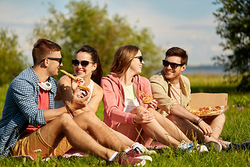 Image showing friends eating pizza at picnic in summer park