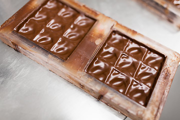 Image showing chocolate in candy mold at confectionery shop