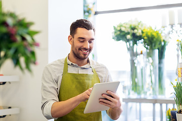 Image showing man with tablet pc computer at flower shop