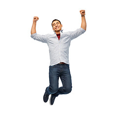 Image showing happy young man jumping over white background