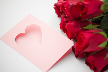 Image showing close up of red roses and greeting card with heart