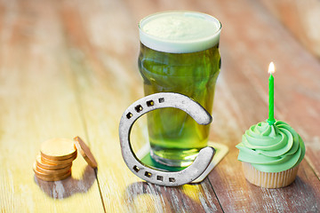 Image showing glass of beer, cupcake, horseshoe and gold coins