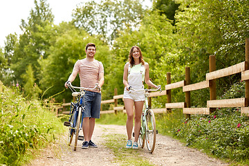 Image showing happy couple with bicycles at summer park