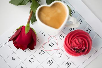 Image showing close up of calendar, coffee, cupcake and red rose