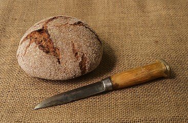 Image showing traditional finnish rye bread on burlap and finnish knife puukko