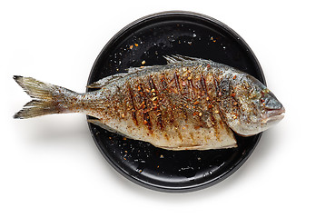 Image showing Grilled fish on black plate
