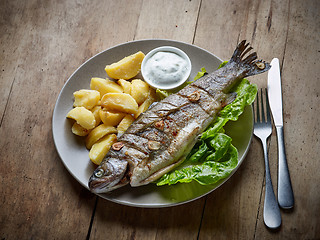 Image showing grilled fish on wooden kitchen table