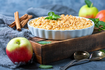 Image showing  Apple crumble in white ceramic baking form.