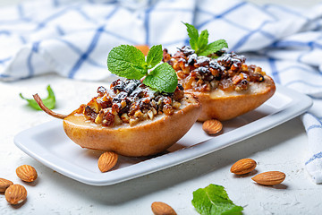 Image showing Pears baked with raisins, nuts, honey and mint.