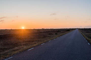 Image showing Sunrise by a straight country road in a great plain grassland