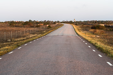 Image showing Morning sunshine at a country road in a barren grassland