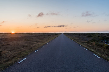 Image showing Straight road by sunrise in a great barren landscape