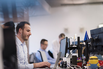 Image showing businessman working using a laptop in startup office