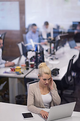 Image showing businesswoman using a laptop in startup office