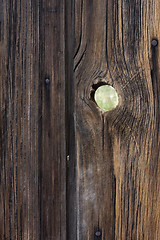 Image showing peephole - weathered wood background with a knothole