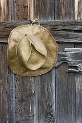 Image showing straw cowboy hat and weathered wood