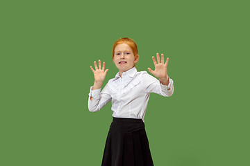 Image showing Portrait of the scared teen girl on green