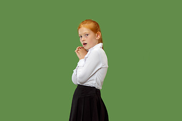 Image showing Portrait of the scared teen girl on green