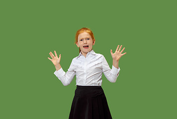 Image showing Portrait of the scared teen girl on green