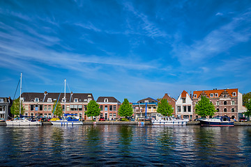 Image showing Boats and houses on Spaarne river. Haarlem, Netherlands