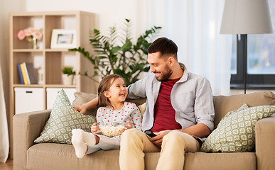 Image showing happy father and daughter watching tv at home