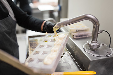 Image showing confectioner makes chocolate candies at sweet-shop