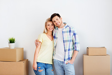 Image showing happy couple with boxes moving to new home