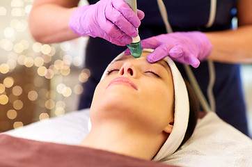 Image showing woman having microdermabrasion facial treatment