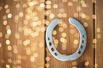 Image showing old horseshoe on wooden background