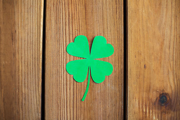 Image showing green paper shamrock on wooden background