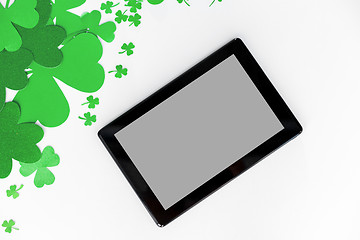 Image showing tablet pc and st patricks day decorations on white