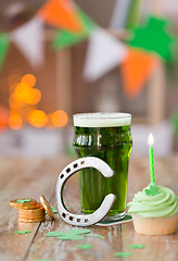 Image showing glass of beer, cupcake, horseshoe and gold coins