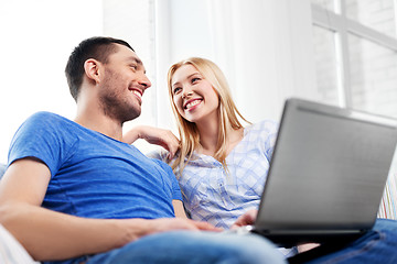 Image showing happy couple with laptop computer at home