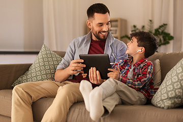 Image showing father and son listening to music on tablet pc