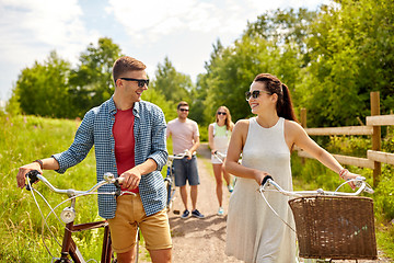 Image showing happy couple with bicycles at summer park