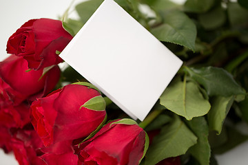 Image showing close up of red roses and letter or note