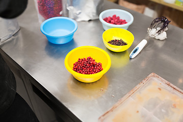 Image showing berries in bowls at confectionery shop kitchen