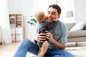 Image showing happy father with little baby daughter at home