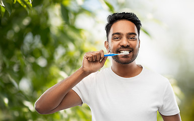 Image showing indian man with toothbrush cleaning teeth