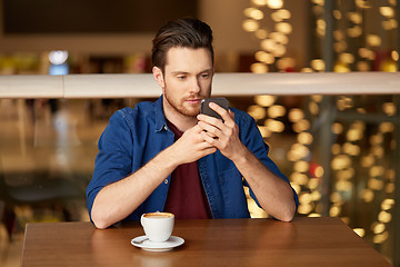 Image showing man with coffee and smartphone at restaurant