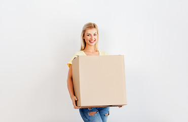 Image showing happy woman holding big cardboard box